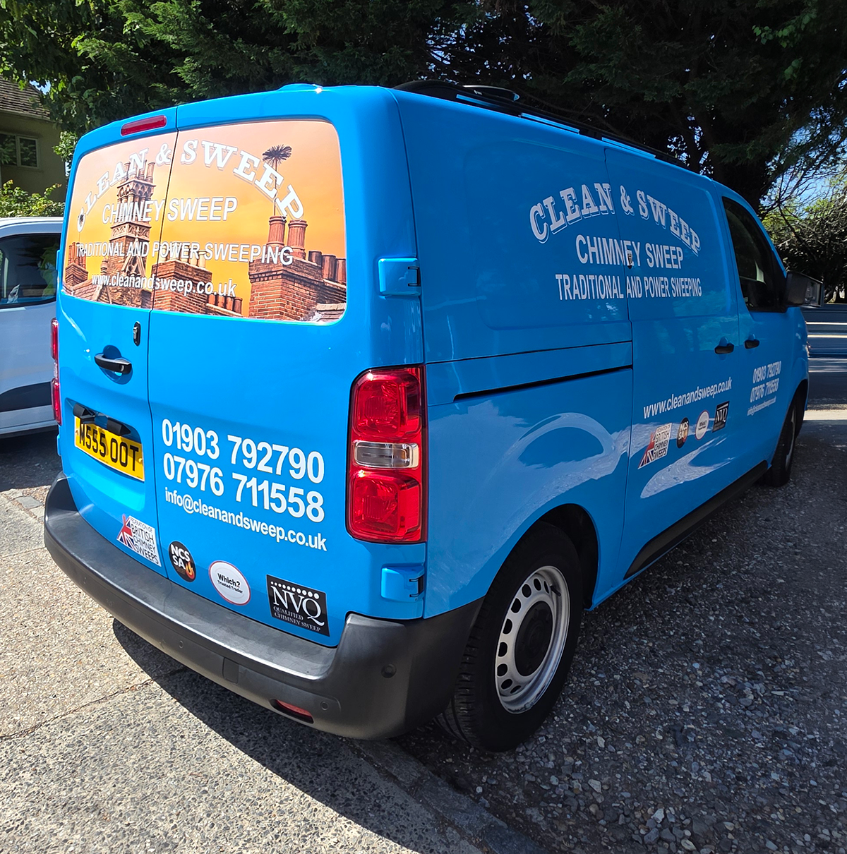Clean & Sweep blue van with vehicle graphics shown on side and rear doors