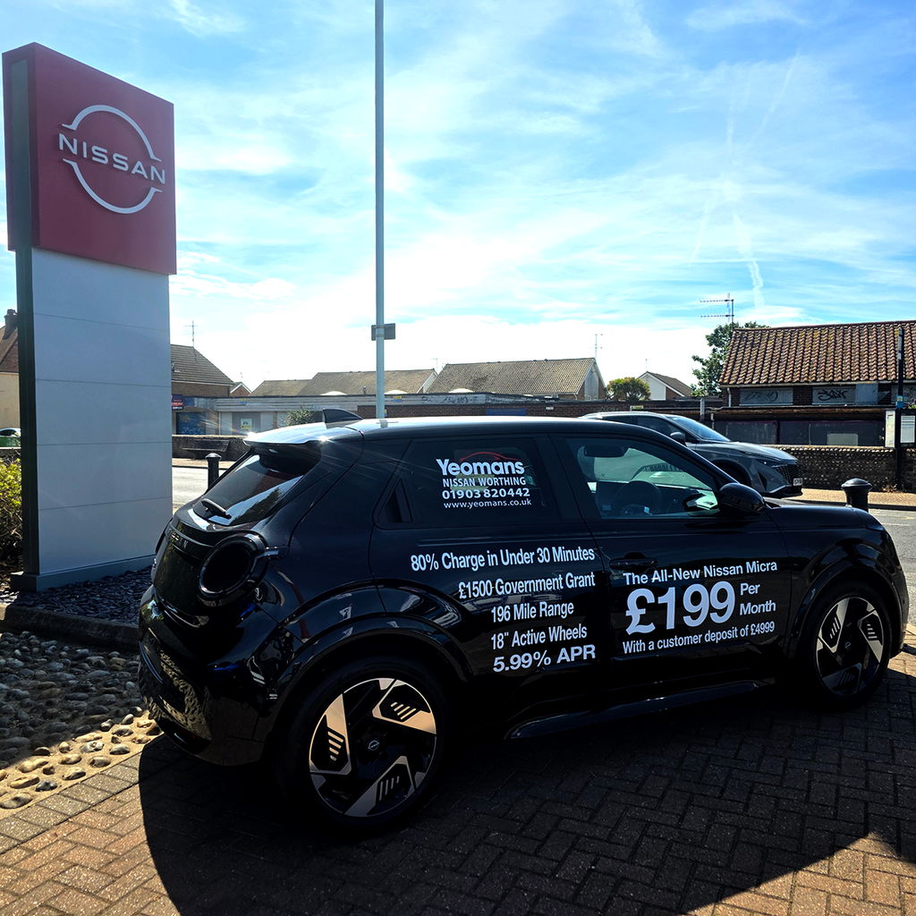 Black Nissan electric car with professional Purple Signs vehicle graphics and promotional lettering